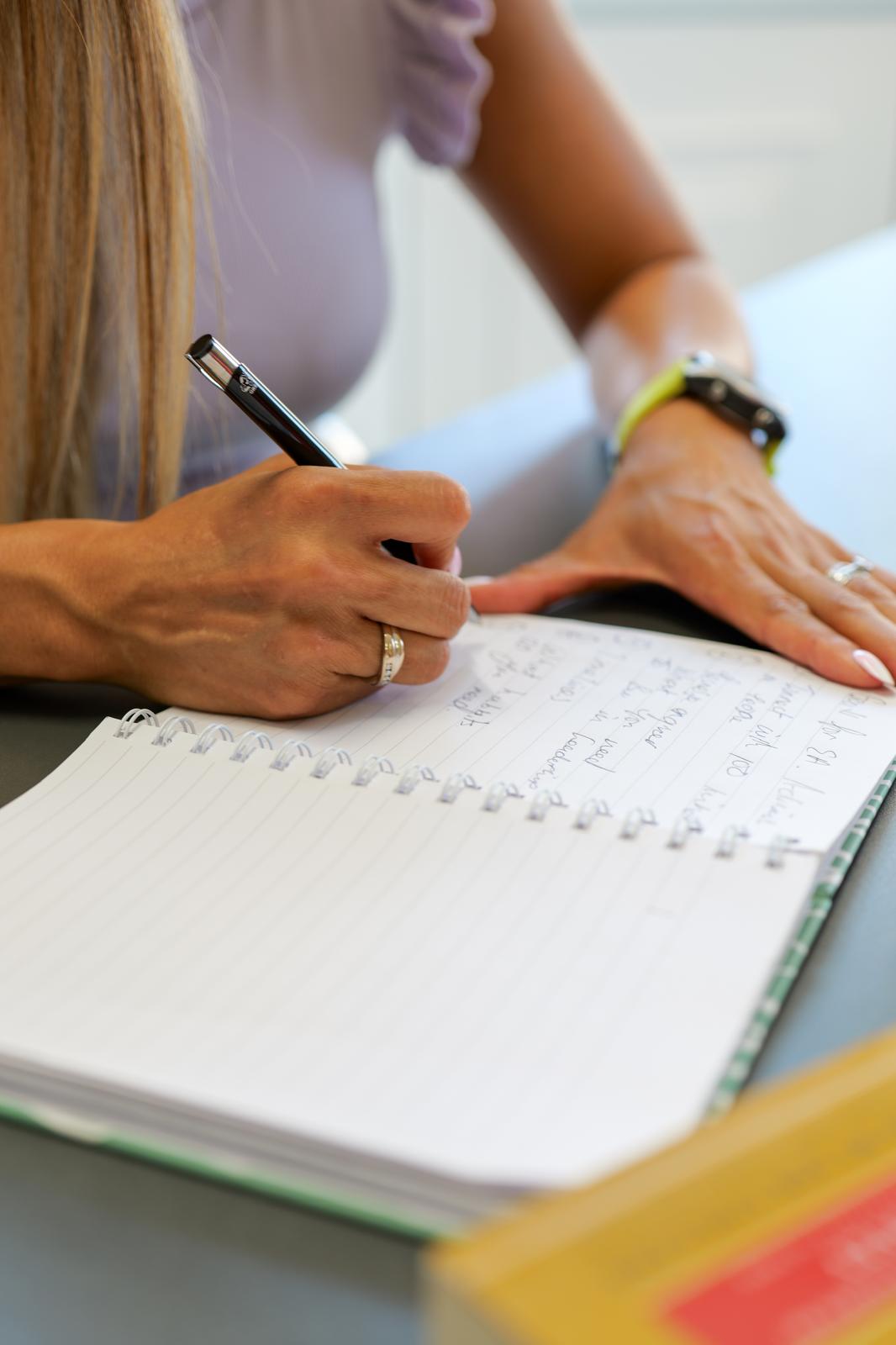 A close-up of Betsy writing in her notebook